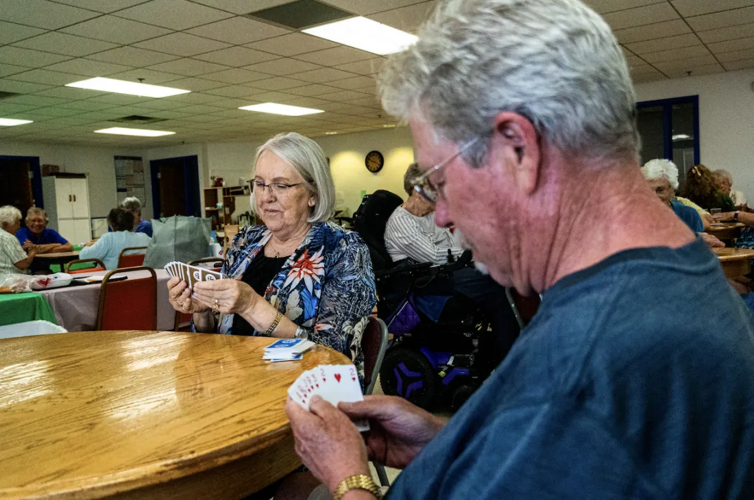 Seniors playing cards together at The Center