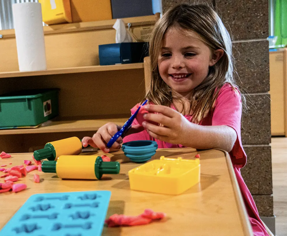 Children learning at a table in the Learning Korner classroom