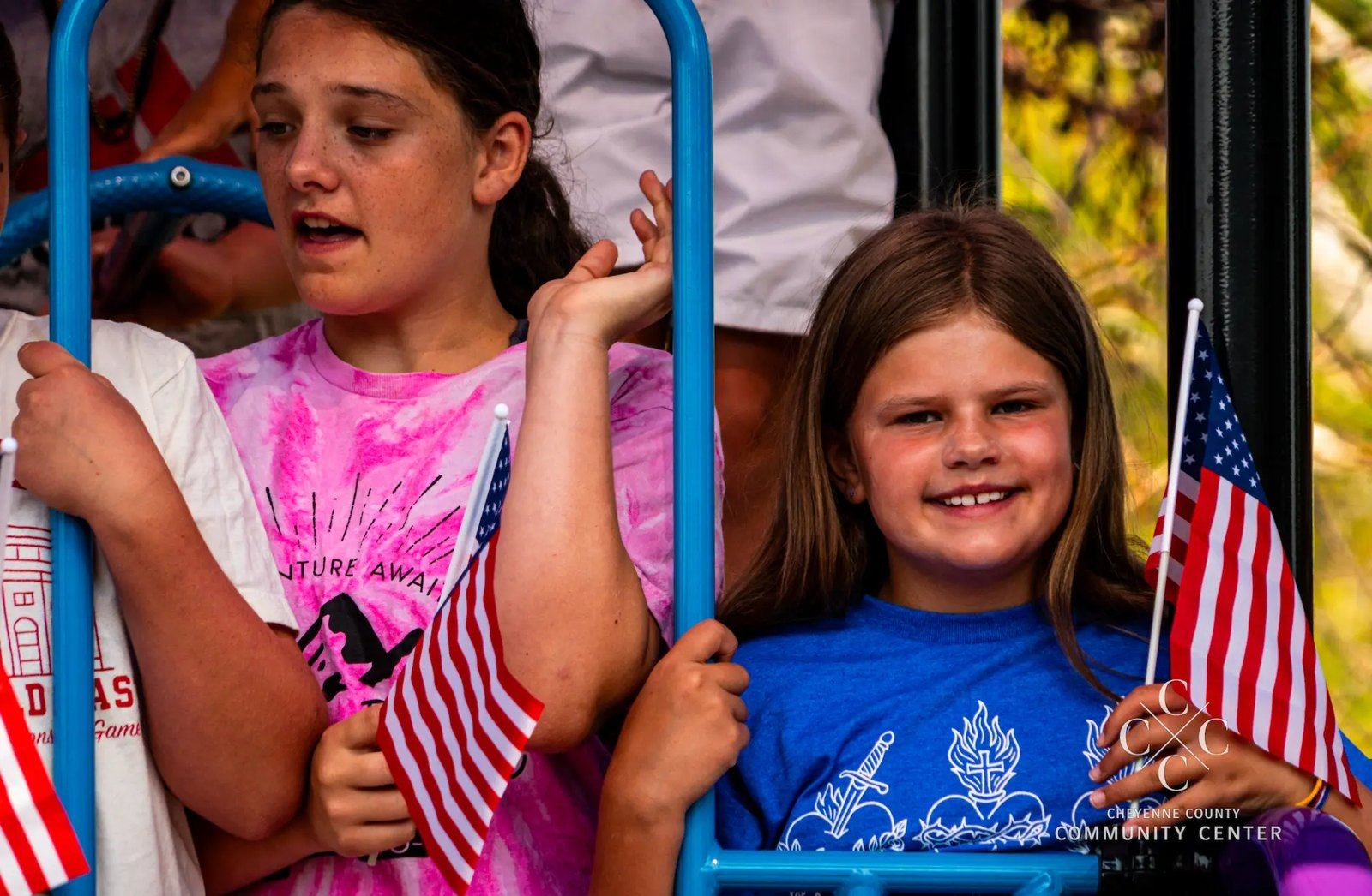 Sidney community parade float with kids waving flags