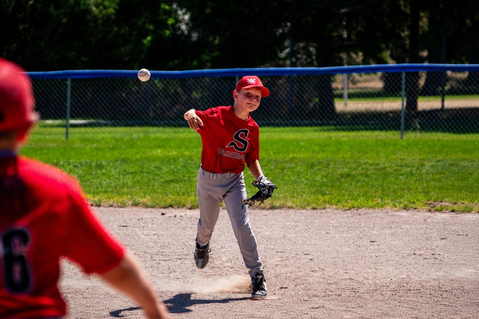 Young Center athlete throwing from the infield during a youth game
