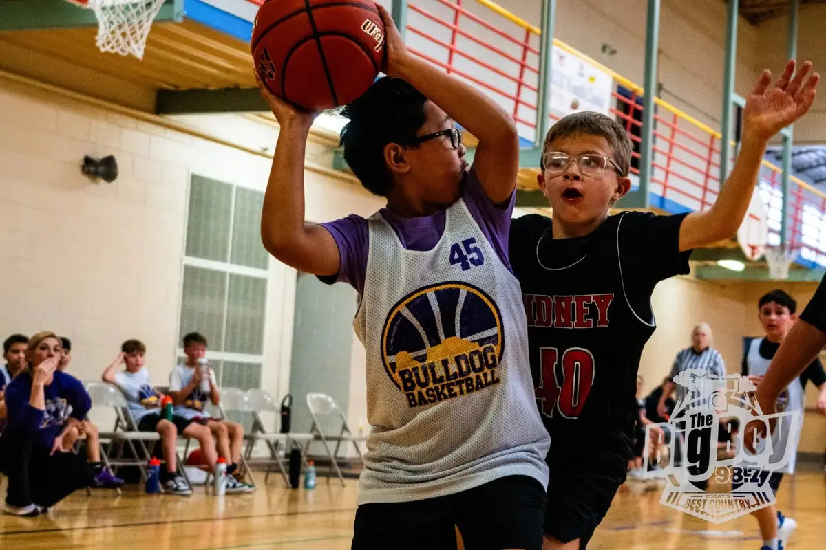 Youth basketball players competing for a shot in the gymnasium at The Center